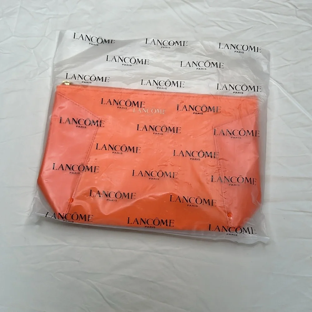 BEAND NEW! Vibrant Orange Cosmetic Bag with Glossy Finish and Zipper Closure.